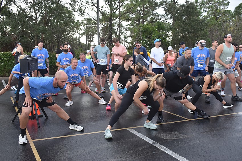 Community members stretch before beginning the Suncoast Stars Community's second annual Stride to Thrive 5K.