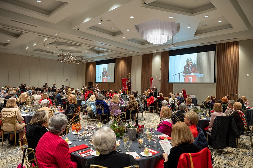 Junior League Lunch begins with Luncheon Chair Cindy Kaiser speaking.