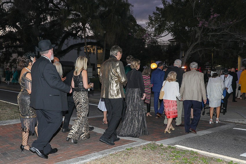 The Avant-Garde conga line crosses the street during the 30th annual party.