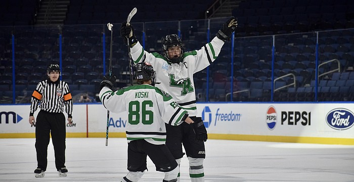 Forward Chase Koski (86) and defenseman Jackson Ellis (4) celebrate a goal Feb. 6 for Lakewood Ranch boys hockey in the Lightning High School Hockey League's title game. The Mustangs have become the premier high school-level team for skaters in the region.