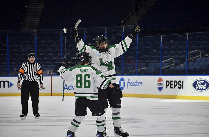 Forward Chase Koski (86) and defenseman Jackson Ellis (4) celebrate a goal Feb. 6 for Lakewood Ranch boys hockey in the Lightning High School Hockey League's title game. The Mustangs have become the premier high school-level team for skaters in the region.
