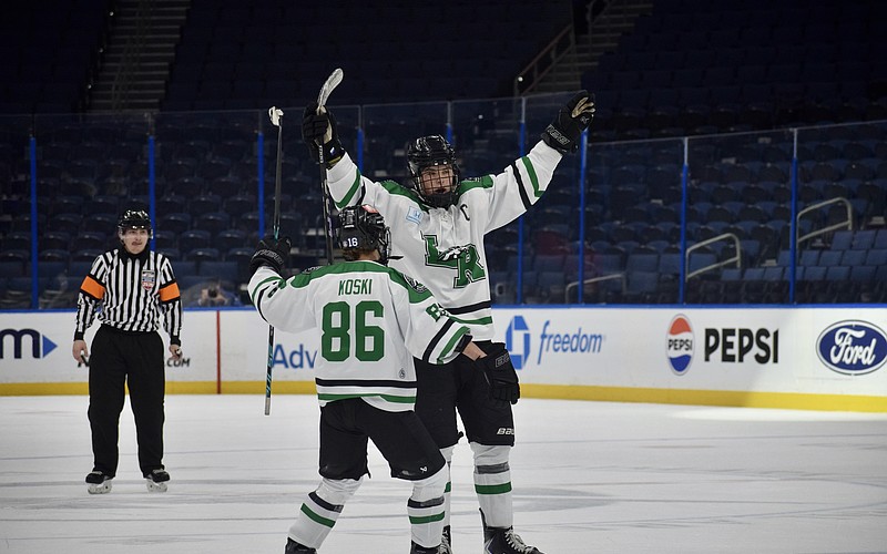 Forward Chase Koski (86) and defenseman Jackson Ellis (4) celebrate a goal Feb. 6 for Lakewood Ranch boys hockey in the Lightning High School Hockey League's title game. The Mustangs have become the premier high school-level team for skaters in the region.