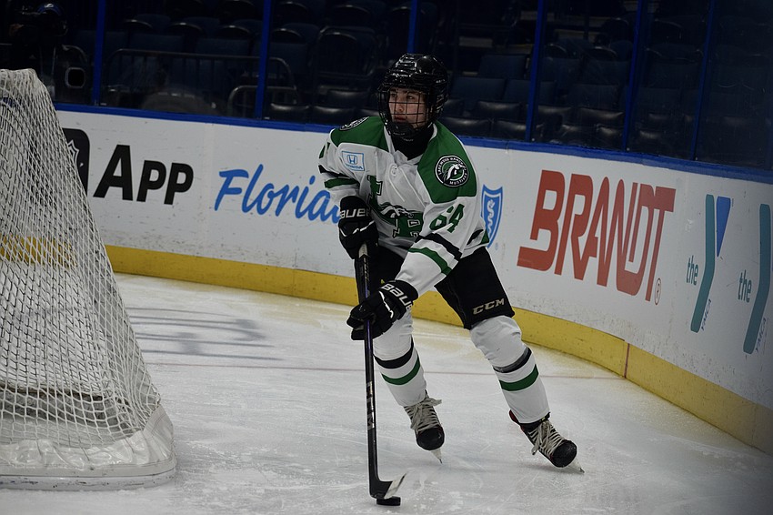 Junior forward Carter Bagshaw brings the puck behind the net during the Lightning High School Hockey League's 2026 title game at Benchmark International Arena. Like many of his Lakewood Ranch teammates, he also skates for Gulf Coast Flames at the club level.
