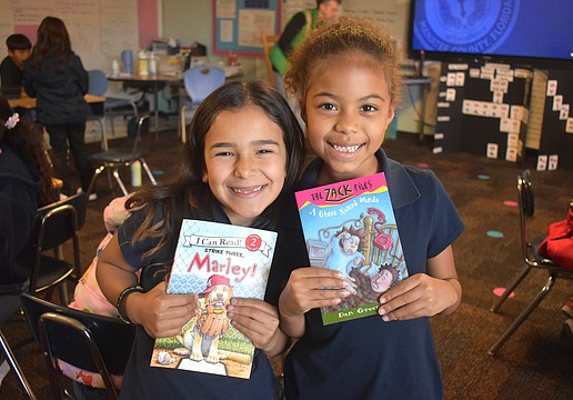 Linda Medina and Aliana Donald, second graders at Daughtrey Elementary, are eager to answer any questions Miss Gina might ask about the books she reads.