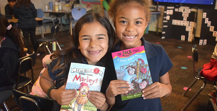 Linda Medina and Aliana Donald, second graders at Daughtrey Elementary, are eager to answer any questions Miss Gina might ask about the books she reads.