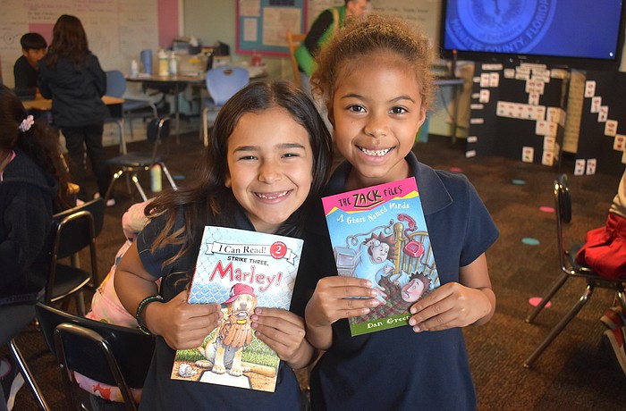 Linda Medina and Aliana Donald, second graders at Daughtrey Elementary, are eager to answer any questions Miss Gina might ask about the books she reads.