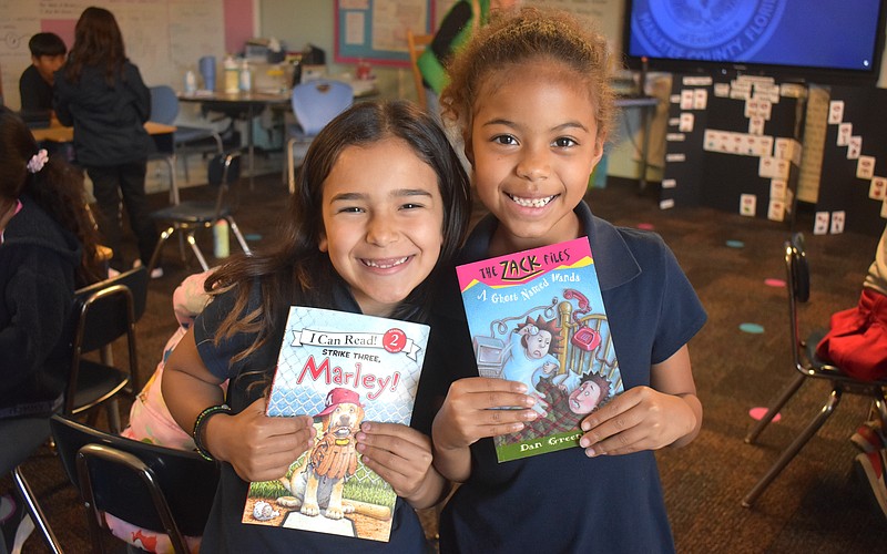 Linda Medina and Aliana Donald, second graders at Daughtrey Elementary, are eager to answer any questions Miss Gina might ask about the books she reads.