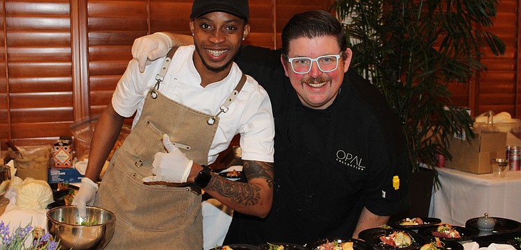 Javaughn Wallace and executive chef Michael from Drift at Lido Beach Resort dish up a poached pear and prosciutto bite at the 15th annual Taste of the Keys on Feb. 26 at the Longboat Key Club Harbourside Ballroom.