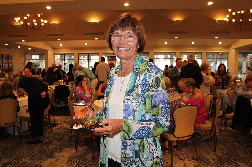 Taste of the Keys attendee Carol Teets tries out the sweet potato and lentil curry with spinach and kale from The Resort at Longboat Key Club.