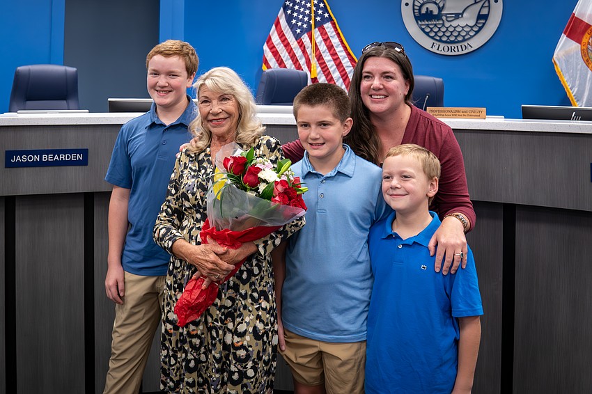Commissioner Carol Ann Felts is surrounded by the Jessee family after being sworn into office. From left to right: Tyler Jessee, Felts, Nate, Stacy and Zack Jessee.