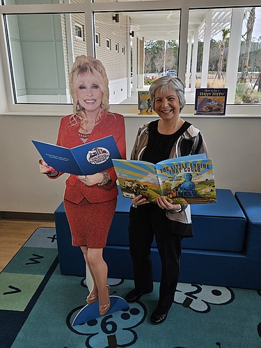 Linda Mahran, founder of the Flagler County Early Literacy Endowment, poses with a cutout of Dolly Parton, whose Imagination Library program the endowment was created to sustain. The program delivers free books monthly to enrolled Flagler County children from birth to age five. Courtesy photo