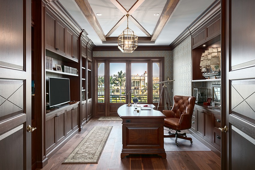 A home office overlooks the water.