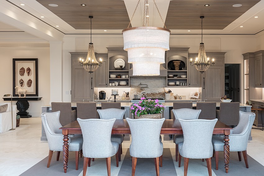 A large chandelier forms a centerpiece over the dining area.