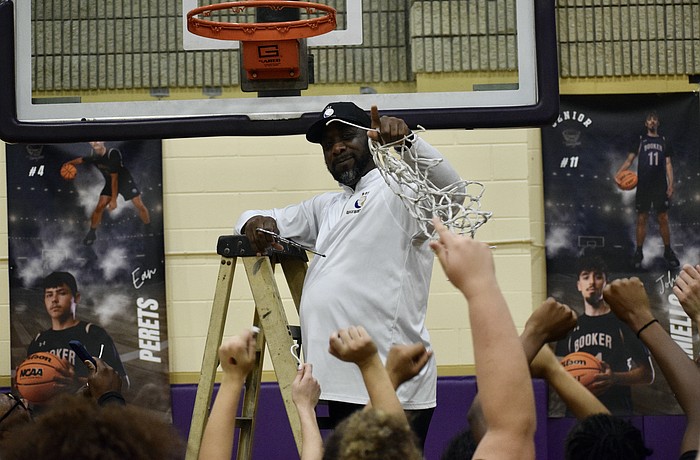 Coach Ty Bryant cuts down the net Feb. 27 after Booker girls basketball's FHSAA Class 4A-Region 3 championship. The Tornadoes have now reached the state semifinals in four of six seasons under his direction.