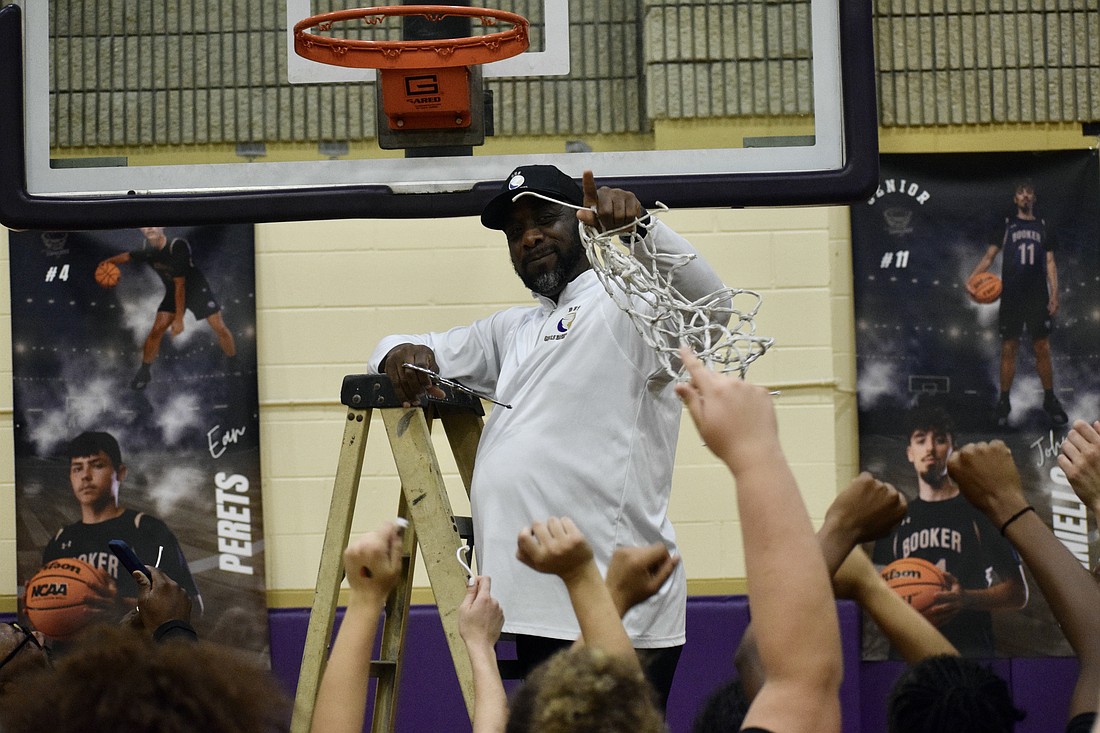 Coach Ty Bryant cuts down the net Feb. 27 after Booker girls basketball's FHSAA Class 4A-Region 3 championship. The Tornadoes have now reached the state semifinals in four of six seasons under his direction.