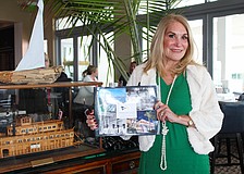 Lynne Short, chair of the Centennial Committee at the Sarasota Yacht Club, shares how the club dove into its own history to produce a book and a full year of events based on the past 100 years. She stands beside a model of the Zalophus, a 125-foot yacht John Ringling purchased in 1922.