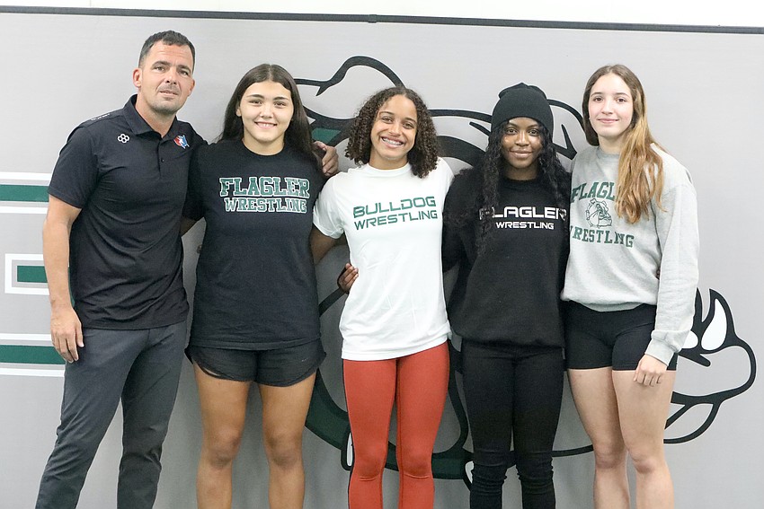 FPC wrestling coach David Bossardet with state wrestling qualifiers Alexa Calidonio, Juliana Mills, Joslyn Johnson and Alisha Vilar. Photo by Brent Woronoff