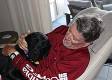 Gracie, who was trained at Dogs Inc., has returned happiness to the life of Lakewood Ranch's Mark Thornsbrough.