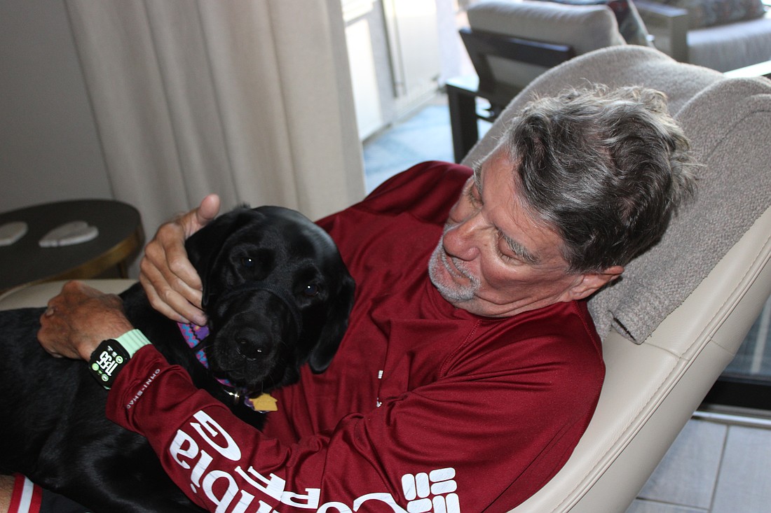 Gracie, who was trained at Dogs Inc., has returned happiness to the life of Lakewood Ranch's Mark Thornsbrough.