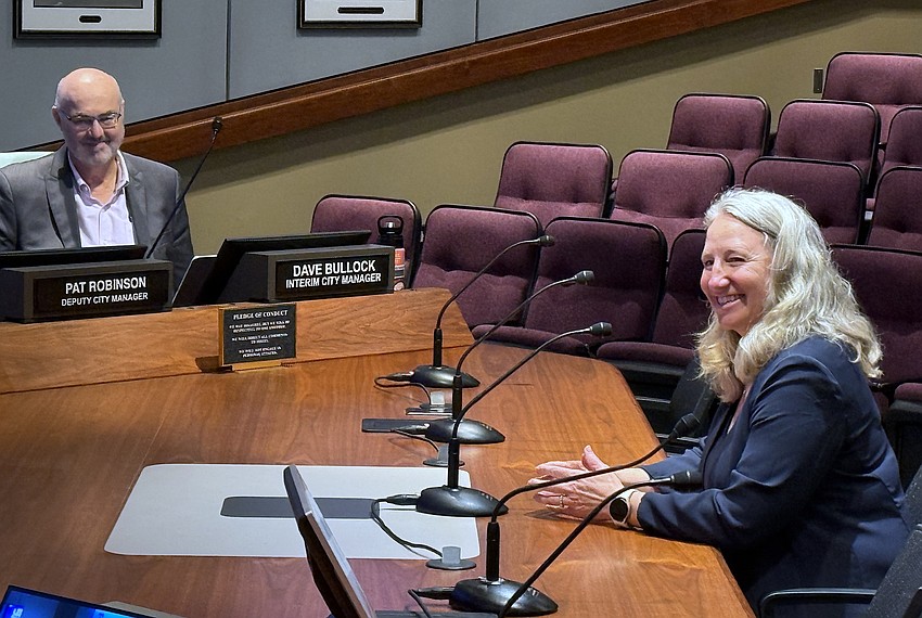 Sarasota Interim City Manager Dave Bullock and his successor as of March 6 Jennifer Jorgensen share a laugh during her confirmation by the City Commission.