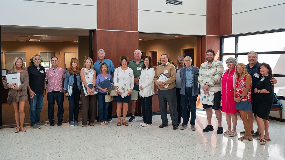 18 of the 30 Citizens Academy graduates pose for a photo at Town Hall after being recognized by town leaders at the March 2 Town Commission meeting for completing the seven-week program.