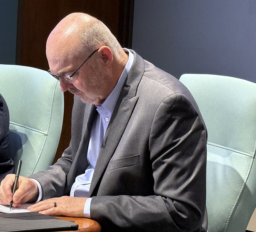 Interim City Manager Dave Bullock takes notes during his final commission meeting on March 2.