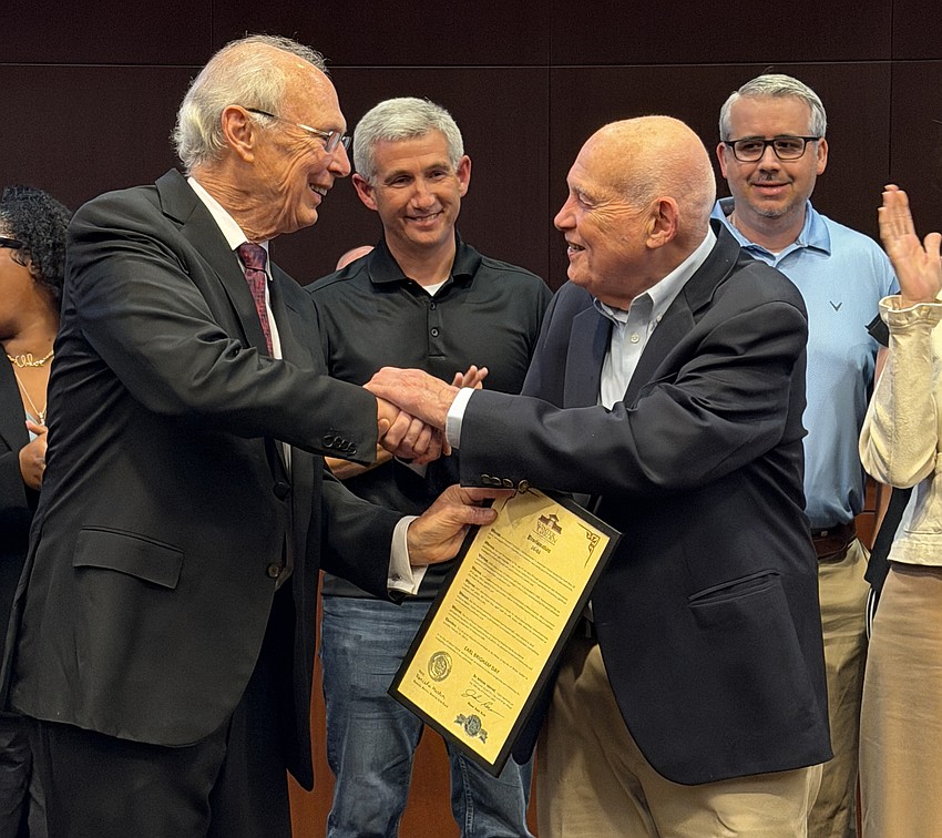 Winter Garden Mayor John Rees shook hands with Earl Brigham after proclaiming Feb. 26 as Earl Brigham Day.