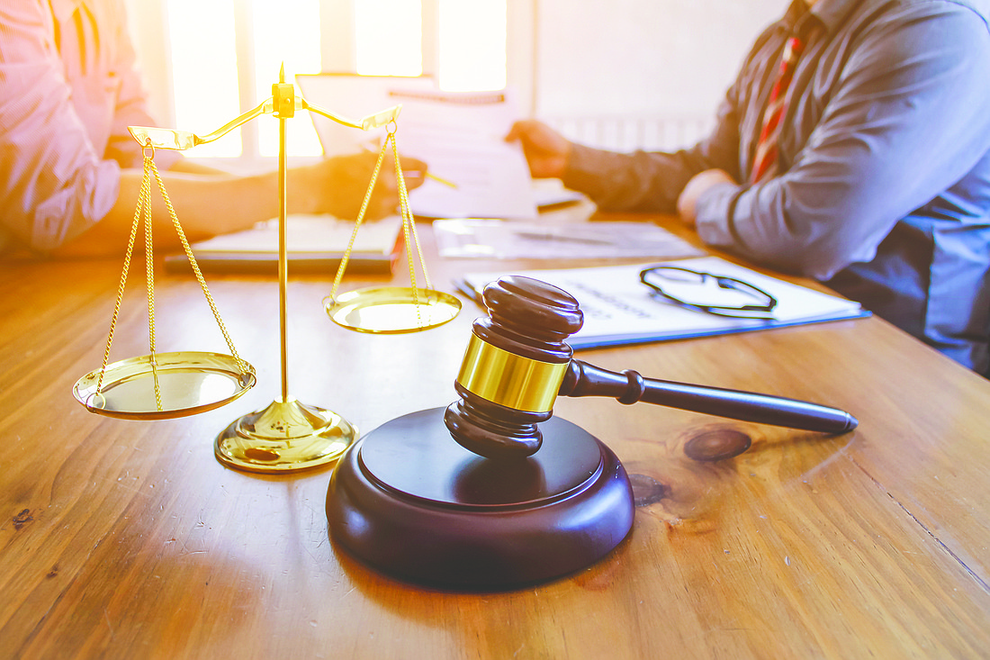 The mallet and brass scales are placed on the table in the lawyer's office for decorative purposes and are a symbol of justice in court decisions.