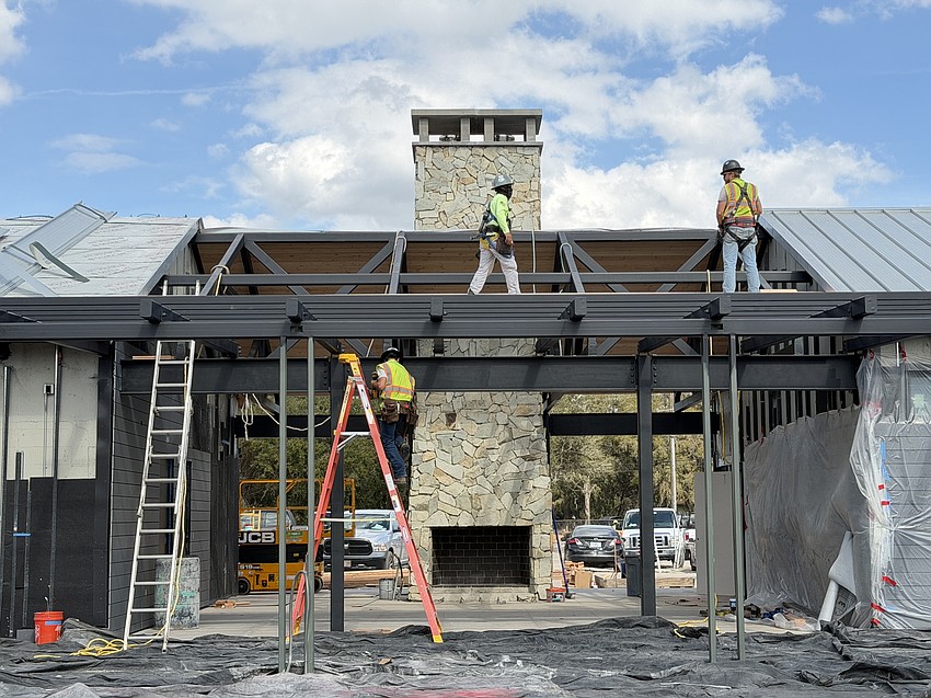 Crews worked on the outdoor kitchen, fireplace, and bathroom and storage space. The trellis will have petrea vines that turn blue during certain times of the year.