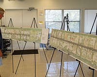 A Sleepy Lagoon resident takes a look at engineering plans at a public meeting at Bayfront Park Wednesday, March 4.