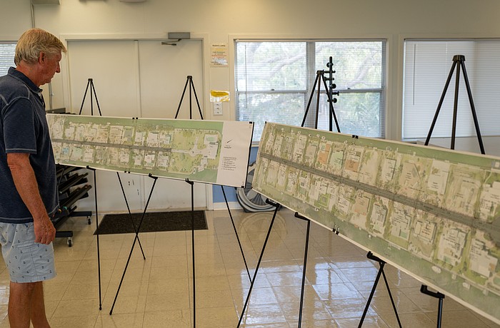 A Sleepy Lagoon resident takes a look at engineering plans at a public meeting at Bayfront Park Wednesday, March 4.