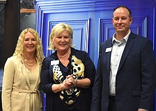 Lakewood Ranch Community Foundation Executive Director Kate Mulligan, Meals on Wheels Plus President and CEO Maribeth Phillips, and Lakewood Ranch Community Foundation President Jeffrey Toale gather together after Phillips accepted a $25,000 grant to beautify Daybreak.