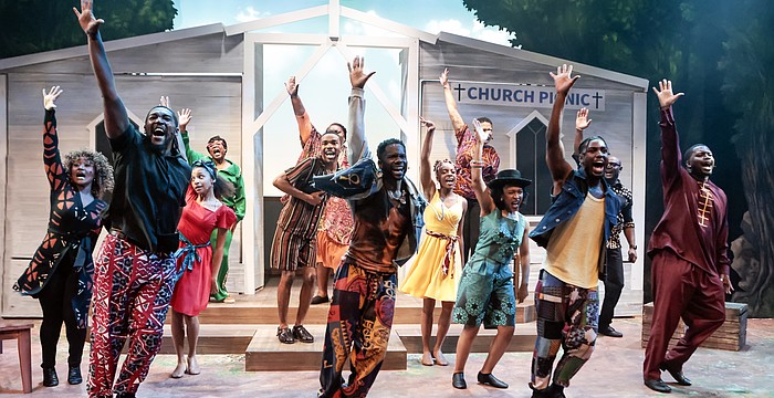 The cast of Westcoast Black Theatre Troupe's "How I Got Over" raise their hands in praise.