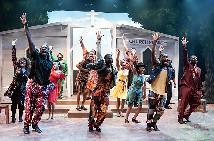 The cast of Westcoast Black Theatre Troupe's "How I Got Over" raise their hands in praise.