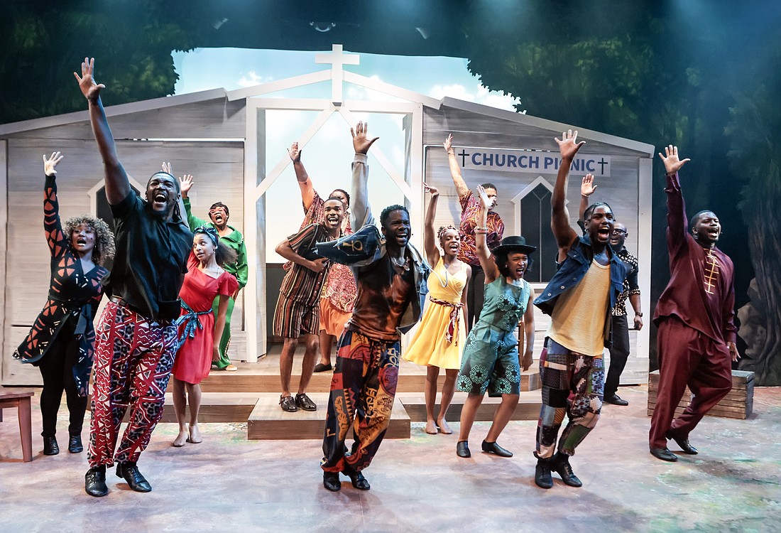 The cast of Westcoast Black Theatre Troupe's "How I Got Over" raise their hands in praise.