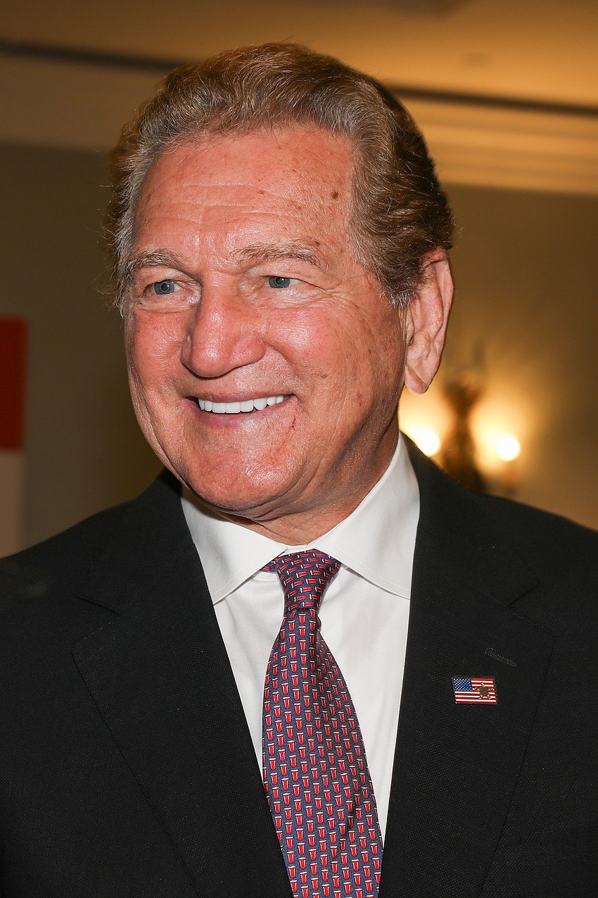 Keynote speaker Joe Theismann autographed a few footballs before lunch.