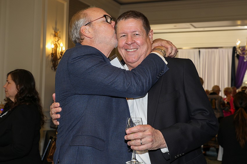 Tom Koski gives a surprise kiss to childhood friend Ken Esthus.
