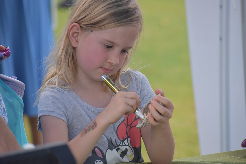 Miyah Berry, 4, colors an oyster shell.