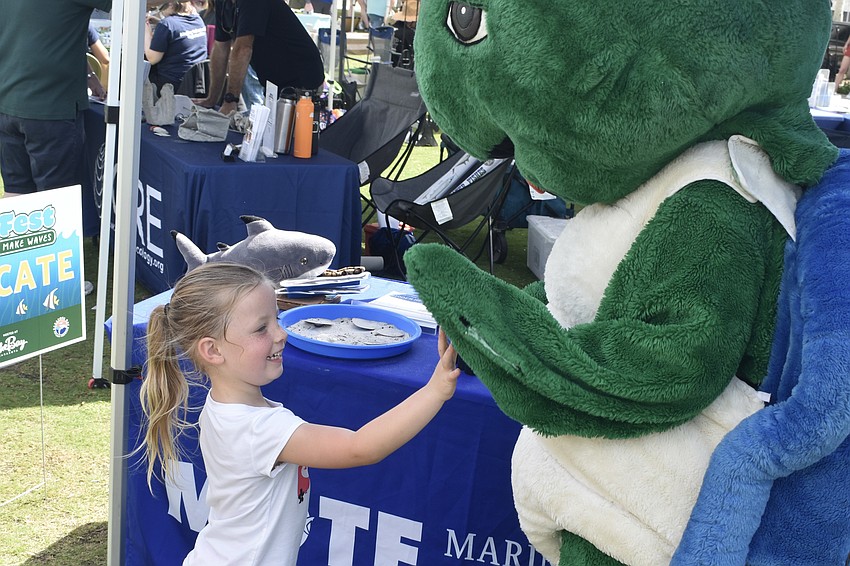 Molly Manning, 6, meets Shelley the Sea Turtle, the mascot of Mote Marine Laboratory & Aquarium.