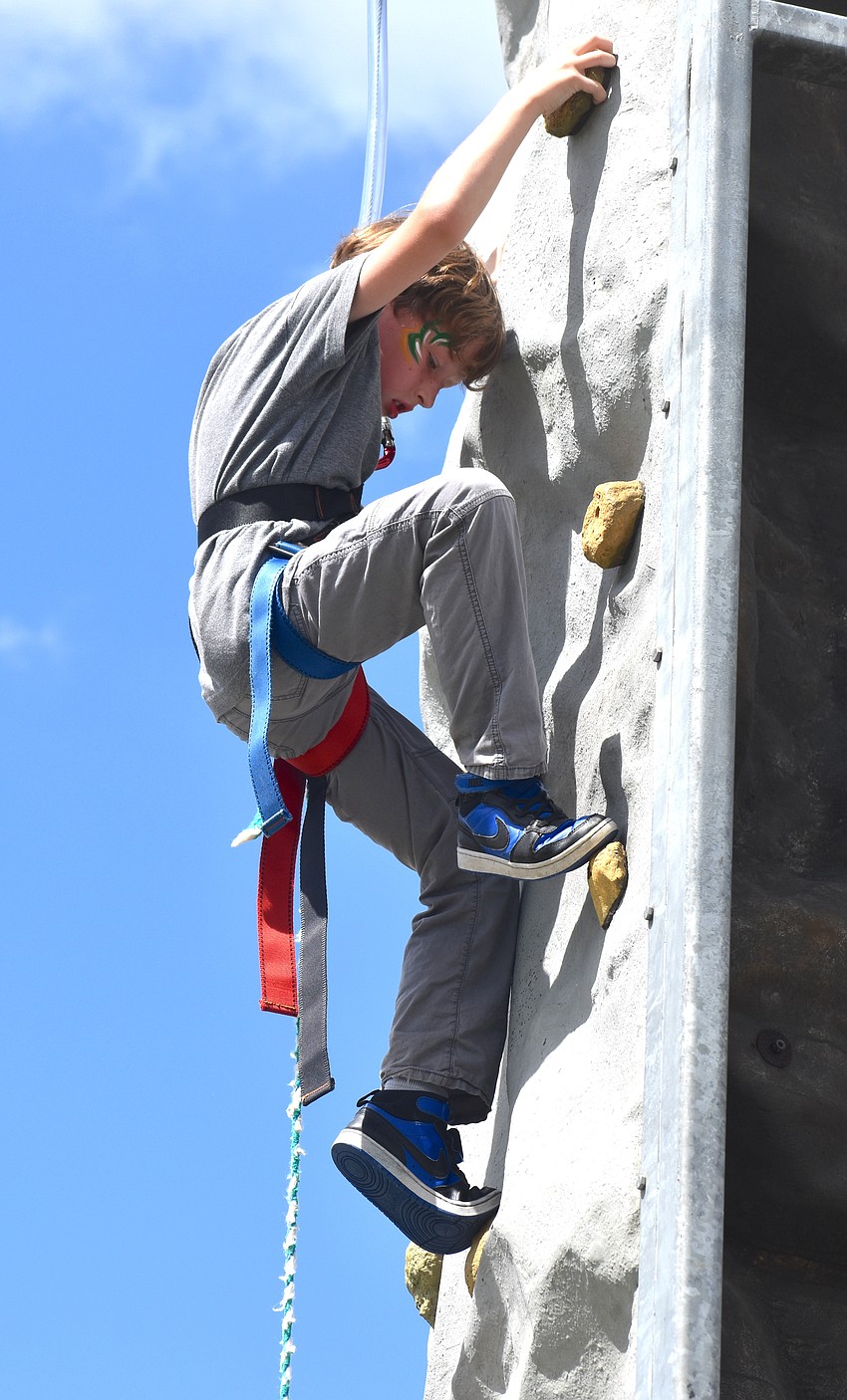 Ellenton’s Hunter Jaworski, 9, says he is scared of heights and was nervous to climb on the climbing wall. He did it to make his friends proud.