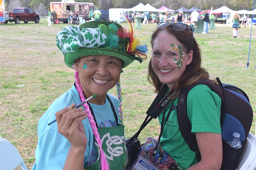 Akiko Campbell of Akiko Graphics paints the face of Lakewood Ranch’s Lynnette Beecher at the Irish Celtic Festival.