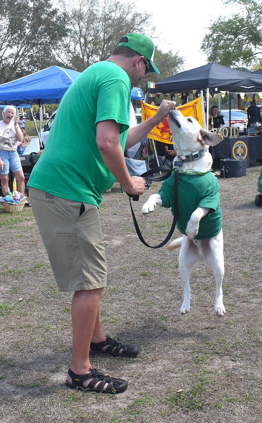 Greenbrook's Chris McElori participates in the Lucky Dog Parade with his 9-year-old lab, Crosby, who jumped for joy in front of the crowd. They won the 