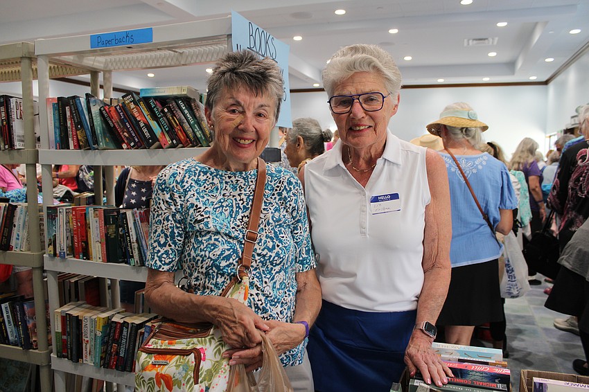 Volunteer Liz Kolber runs into her cousin, Sue Hajduk, at the Royal Rummage Sale.