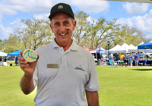 Mark Daunt from The Resort at Longboat Key Club doles out a sweet pick-me-up from the organization’s booth at the 3rd annual Town of Longboat Key Open House on March 7 at the Town Center Green.