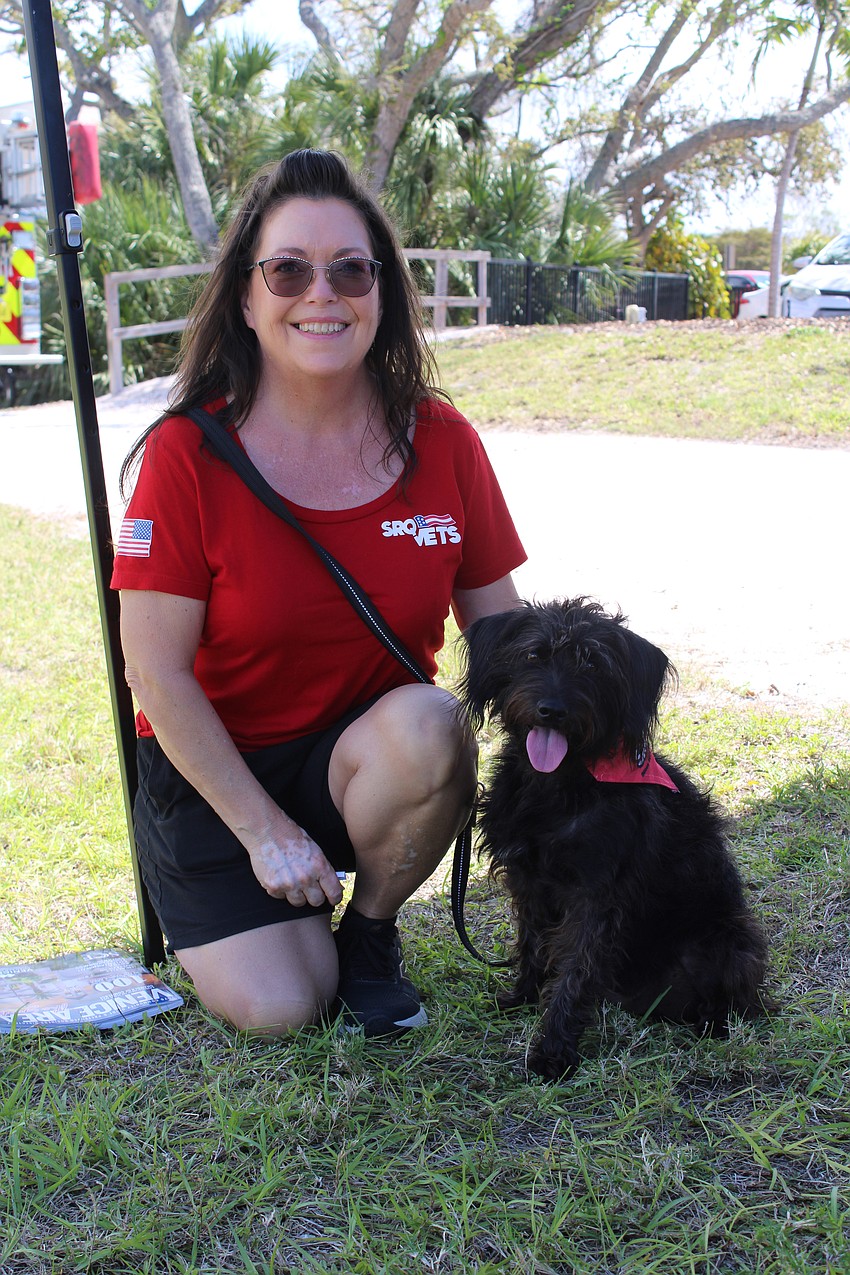 Danielle Kehs and her dog, Raven, check out the food trucks at the open house while taking a break from their booth for SRQ Vets.