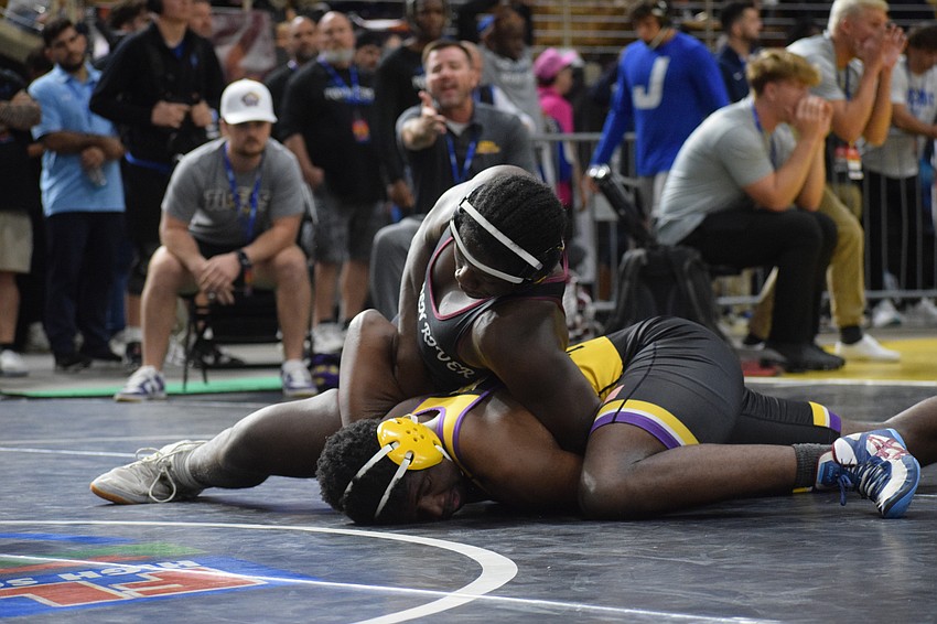 Junior Freedom McDaniel (top) wrestles Columbia sophomore Xavier Williams (bottom). The Pirate won their match by fall, 2-0, in four minutes and 21 seconds en route to fourth place at 215 pounds.