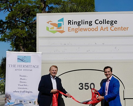 Larry Thompson and Andy Sandberg shake hands on the site of the Englewood Art Center at 350 McCall Road.