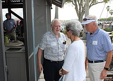 Rex Jensen welcomes Fabienne and Brett Hutchens to the party at the Sarasota Polo Club.
