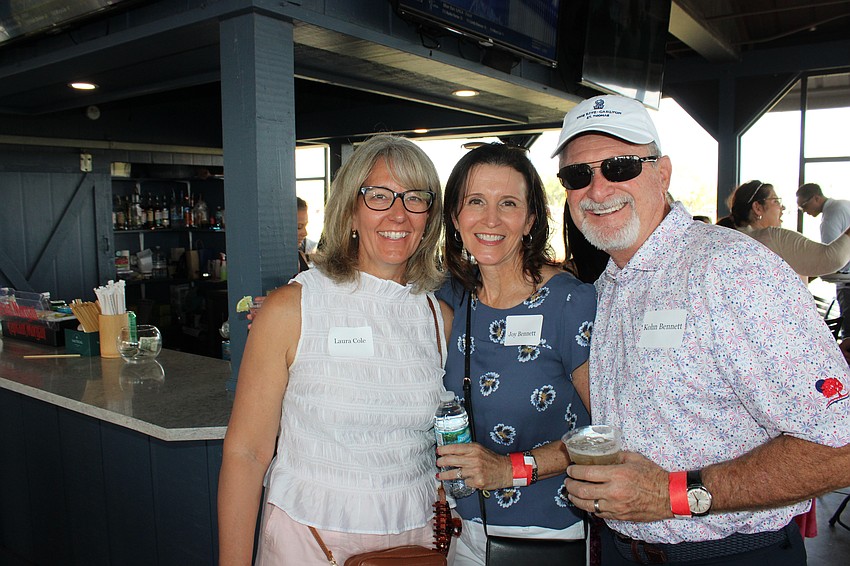 SMR Executive Vice President Laura Cole chats with Joy and Kohn Bennett of Homes by Towne.