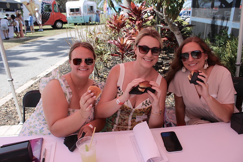 Anyone for a mini-burger? SMR’s Grace Flowers, Nicole Hackle and Taylor Riffle enjoy little burgers during SMR’s party at the Sarasota Polo Fields.